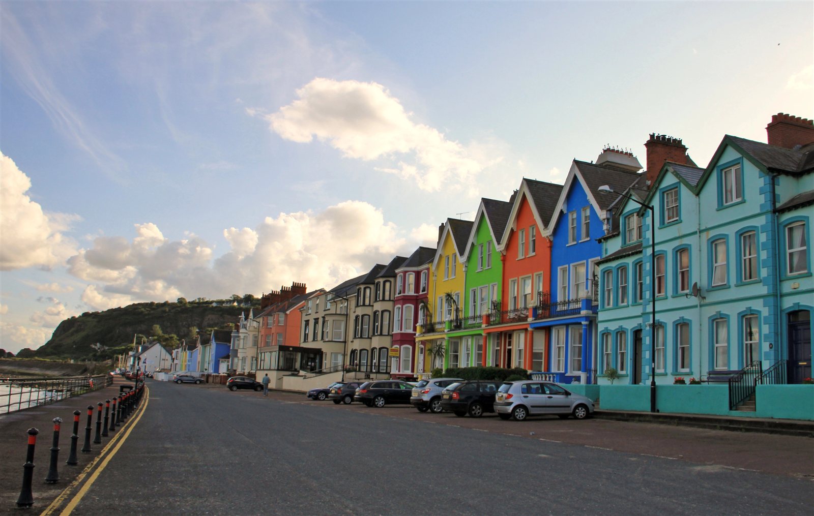 Colourful seaside houses beside a coastal road in Ireland